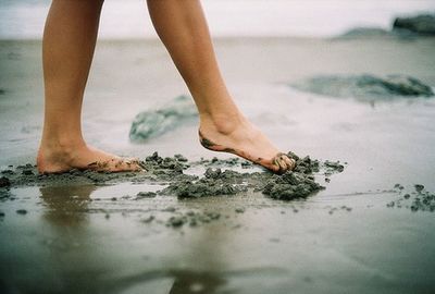 Low section of child legs on wet land