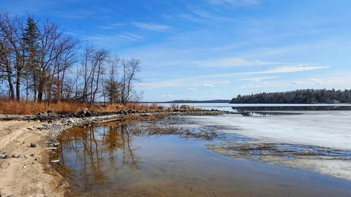 Scenic view of lake against sky during winter