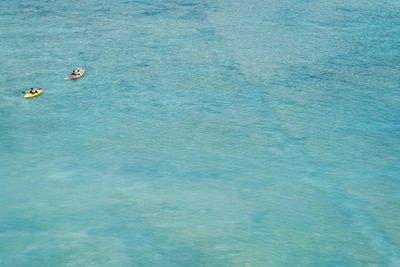 High angle view of people swimming in sea