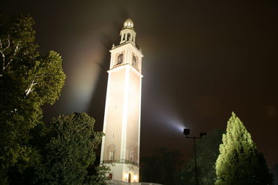 Low angle view of illuminated building against sky at night