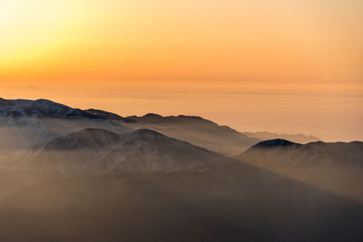 Scenic view of mountains against sky during sunset