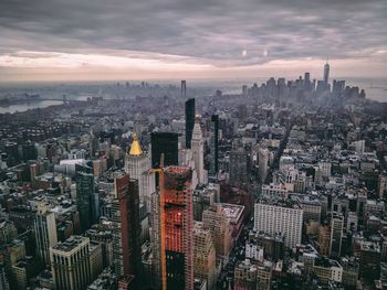 High angle view of modern buildings against sky during sunset