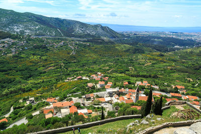 High angle view of houses and mountains against sky