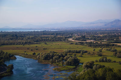 Scenic view of landscape and river against sky