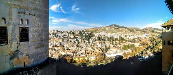 High angle view of buildings in town against sky