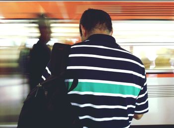 Woman standing on escalator