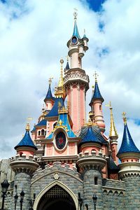 Low angle view of building against cloudy sky