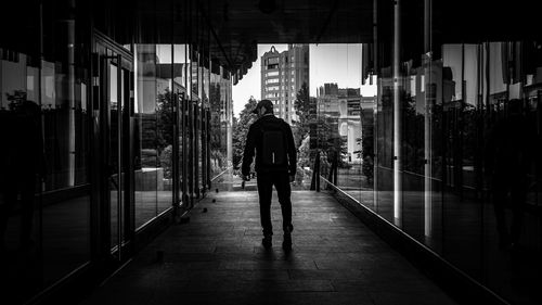 Rear view of man walking in building