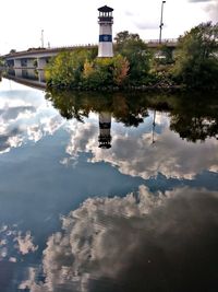 Reflection of building in puddle on lake