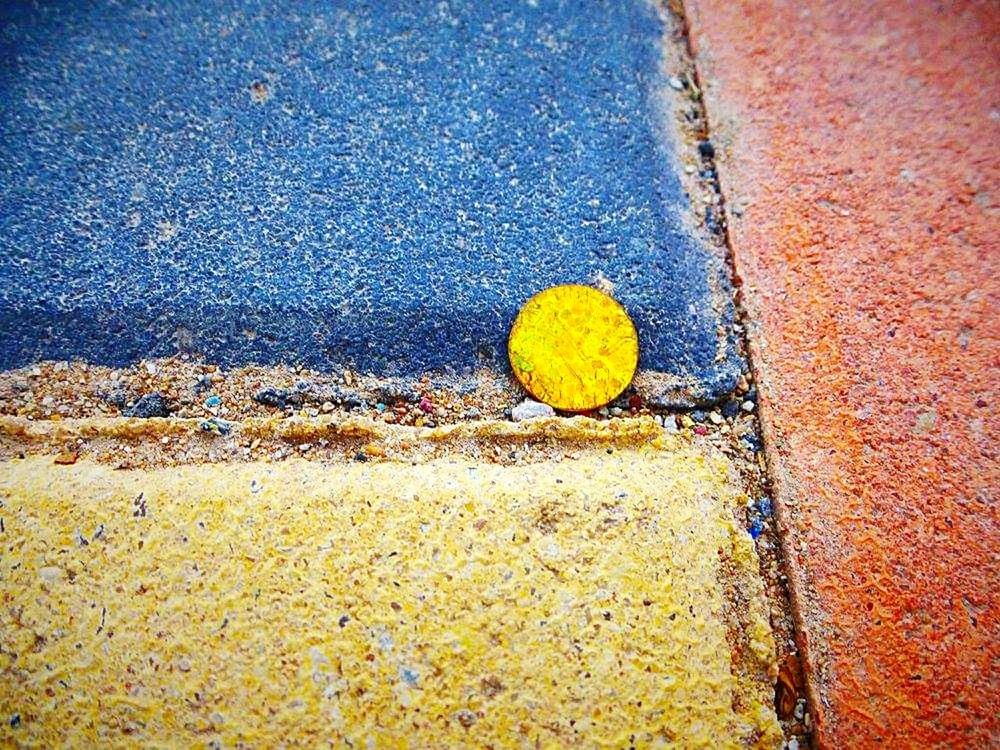 yellow, no people, day, textured, high angle view, close-up, city, transportation, street, outdoors, road, architecture, road marking, nature, wall - building feature, marking, rough, built structure, weathered, footpath