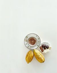 Directly above shot of breakfast on table against white background