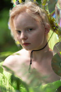 Close-up of young woman in a neon green handmade crown