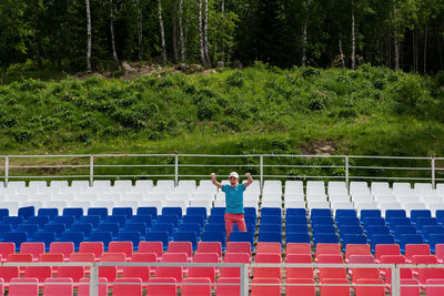 People standing by railing against trees