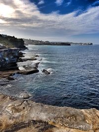Scenic view of sea against cloudy sky