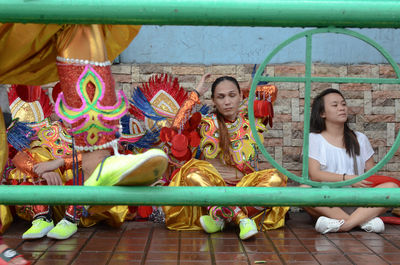 Portrait of smiling girl sitting outdoors