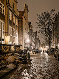 Street amidst buildings against sky in city
