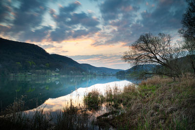 Scenic view of lake against sky during sunset