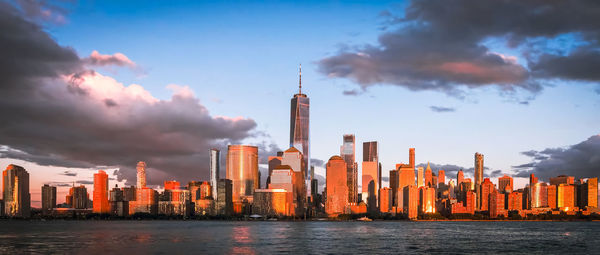 Skyscrapers in city against cloudy sky on sunset.new york city, united states of america