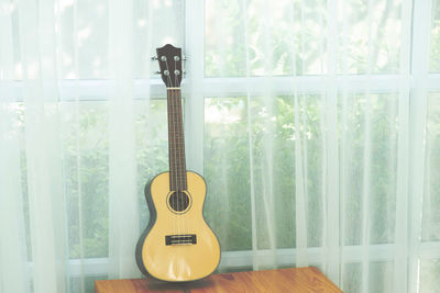 Full frame shot of guitar in glass window