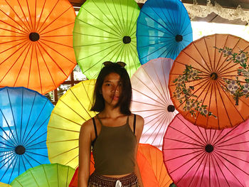 Portrait of woman with multi colored umbrella at chiang mai - thailand 