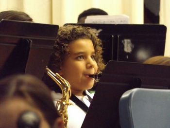 Close-up of man sitting in kitchen