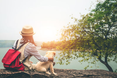 Man with dog against sky
