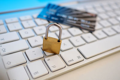 Close-up of padlock and credit card on keyboard