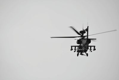 Helicopter flying against sky