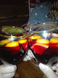 Close-up of hand holding drink on table
