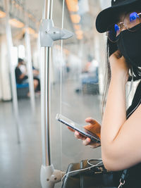 Midsection of woman using mobile phone