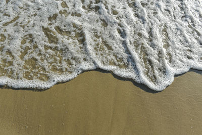 High angle view of surf on beach