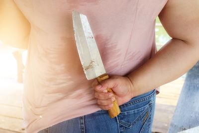 Midsection of woman holding ice cream