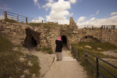 Man standing against old ruin