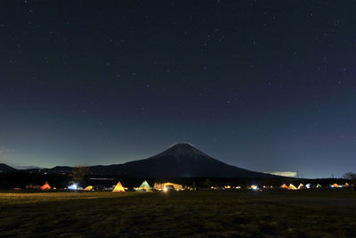 Scenic view of landscape against sky at night