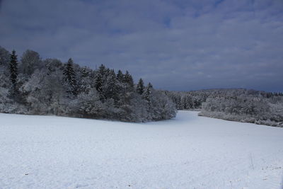 Snow covered land against sky