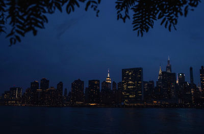 Illuminated buildings against sky at night