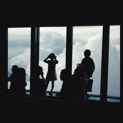 Silhouette of people against cloudy sky