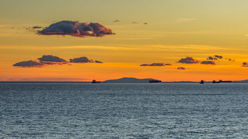 Scenic view of sea against orange sky