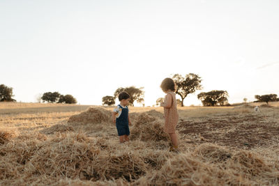 Brother and sister playing in the fields