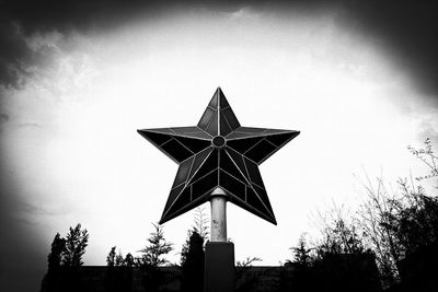 Low angle view of silhouette cross against sky