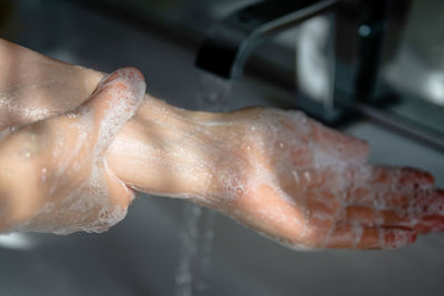 Close-up of hand preparing food at home