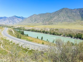 Scenic view of mountains against clear blue sky