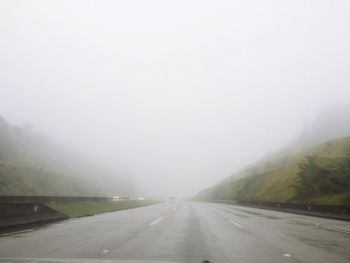 Road passing through foggy weather