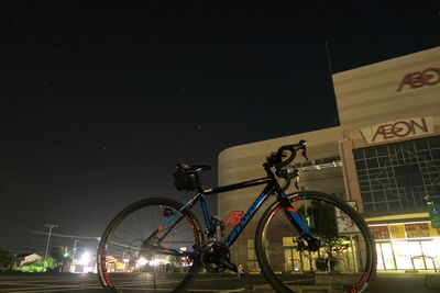 Low angle view of city against sky at night