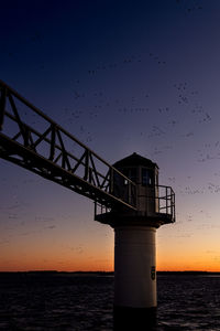 Low angle view of bridge against sky during sunset