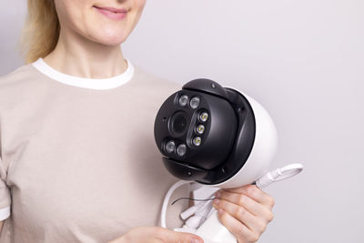 Midsection of woman using telephone