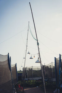 Low angle view of flags against clear sky