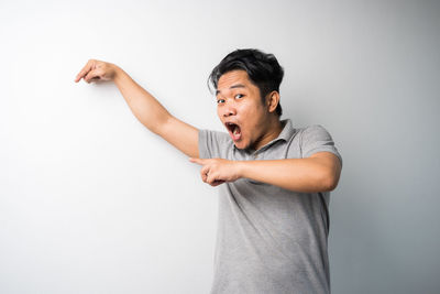 Mid adult man standing against white background