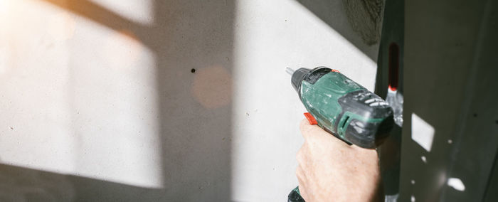 Close-up of man hand on wall