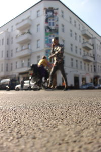 Rear view of woman walking on city street